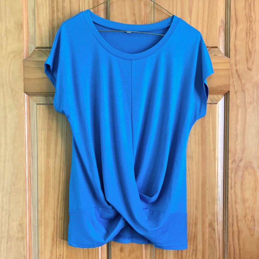 Women’s size medium new without tags blue short sleeved top with front twist